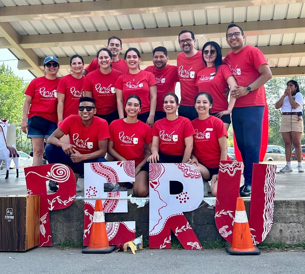 Peru Baila members gathered in team shirts at a community event